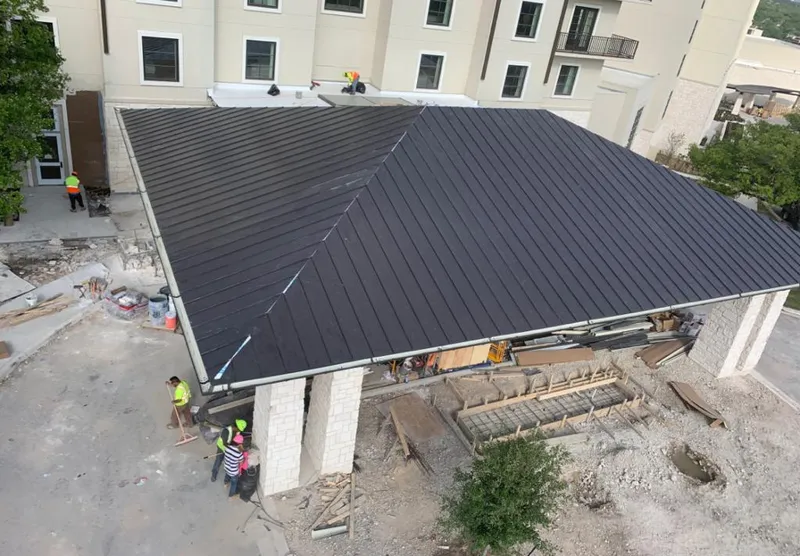 Metal roofing installation team working on a commercial building in Sallisaw