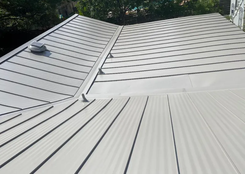 Solar attic fan installed on a metal roof for Roof Ventilation in Sallisaw